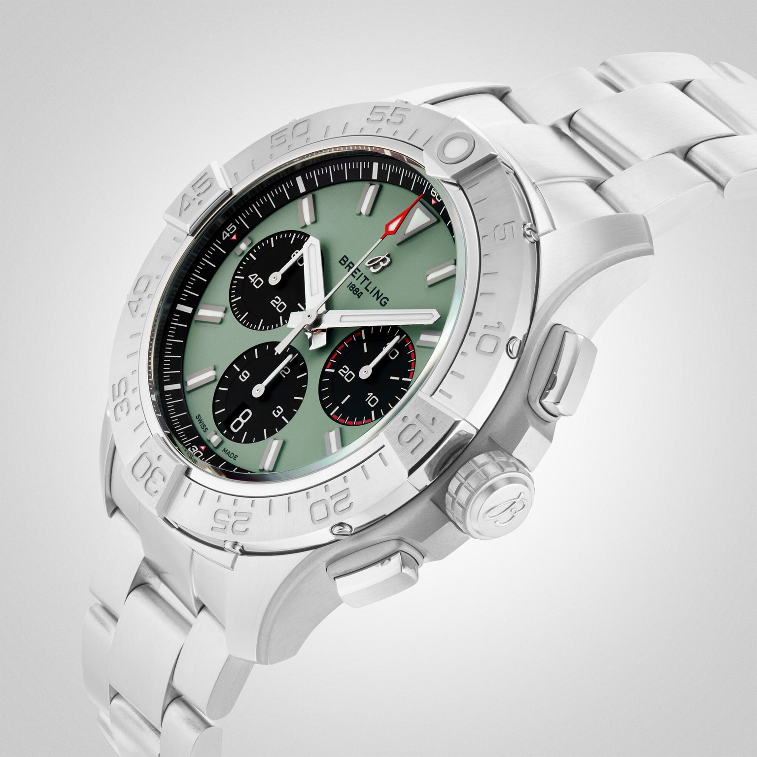 The Breitling Avenger B01 Chronograph 44 is a military-inspired watch with a green dial, three black subdials, and a 44mm stainless steel case on a metal bracelet, displayed on a light gray background.