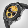 The Breitling Avenger B01 Chronograph 44 Night Mission wristwatch features a yellow dial, black bezel, three subdials, a black textured strap, and a ceramic-titanium case, displayed from an angled perspective.