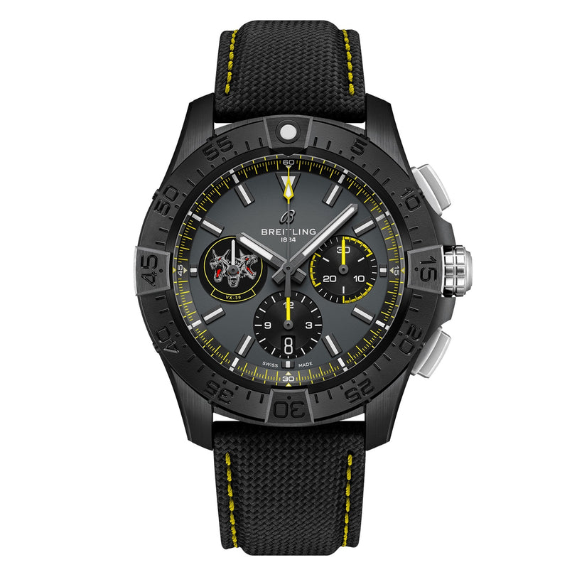 The Breitling Avenger B01 Chronograph 44 Night Mission Bloodhounds features a black case, grey dial with three subdials, yellow accents, and a black textured strap with yellow stitching—driven by the Manufacture Caliber 01.