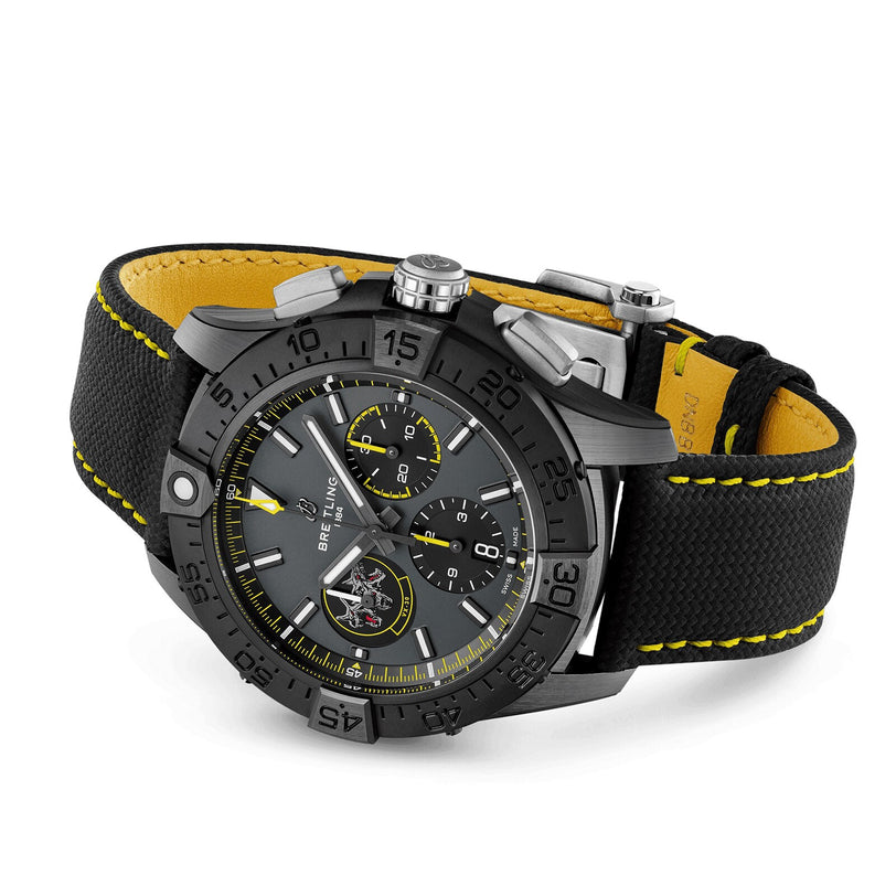 The Breitling Avenger B01 Chronograph 44 Night Mission Bloodhounds features a black dial with three subdials, yellow accents, and a black fabric strap with yellow stitching—powered by the Manufacture Caliber 01 and inspired by U.S. Navy jet pilots.