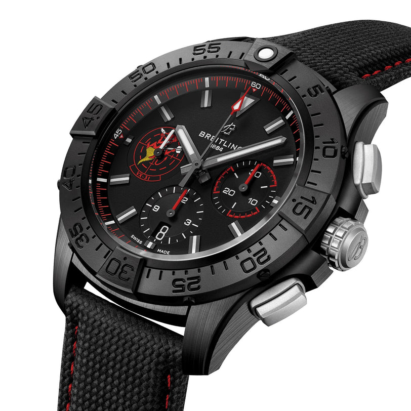 The Breitling Avenger B01 Chronograph 44 Night Mission Dust Devils features a black case with red accents, three subdials, a rotating bezel, and a textured black strap with red stitching, powered by the Manufacture Caliber 01.