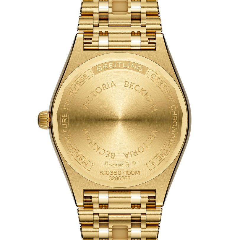 Close-up of the back of a Breitling Chronomat Automatic 36 Victoria Beckham watch in 18K yellow gold, engraved with collaboration details and official branding.