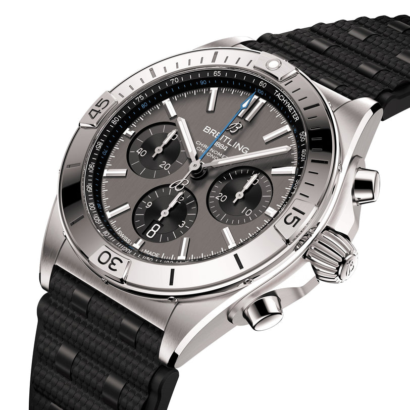 The Breitling Chronomat B01 42 is a stainless steel chronograph watch featuring a black textured rubber strap, three subdials, date display, silver hour markers, and the Breitling 01 calibre movement.