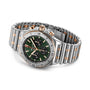 The Breitling Chronomat B01 42, featuring stainless steel and gold, a green dial with three subdials, and a link bracelet, is shown angled on a white background.