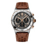 The Breitling Chronomat B01 42 Triumph is a luxury chronograph watch featuring a brown leather strap and a black dial.