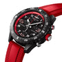 The Breitling Endurance Pro 38 is a black chronograph athleisure watch with an ultra-light Breitlight case, red bezel and strap, plus white dial numbers—ideal for sporty lifestyles. Shown on a white background.