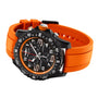 The Breitling Endurance Pro 44 is a black watch featuring a bright orange rubber strap and white accents on the dial and bezel.