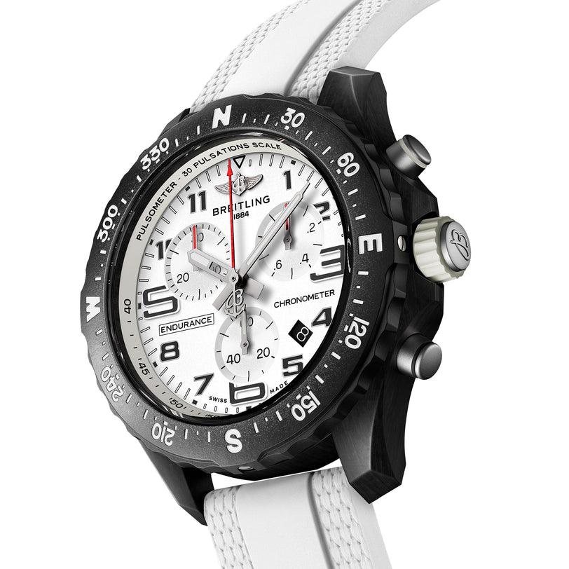 Close-up of the Breitling Endurance Pro 38 The Watches Of Switzerland Group Exclusive, featuring a white strap, black bezel, and white dial with chronograph subdials and black numerals. Chronometer-certified movement included.