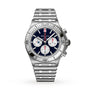 The Breitling Chronomat B01 42 NFL New England Patriots Edition is a silver metal chronograph wristwatch featuring a blue dial with three subdials and a matching metal bracelet.