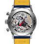 Stainless steel chronograph watch with skeletonized dial, visible mechanical movement, red hands, and yellow and navy leather