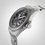A close-up of the Oris ProPilot X Calibre 115 highlights its skeleton dial, stainless steel case and bracelet, exposed Calibre 115 movement, and labeled crown—an authentic Swiss Made mechanical watch.