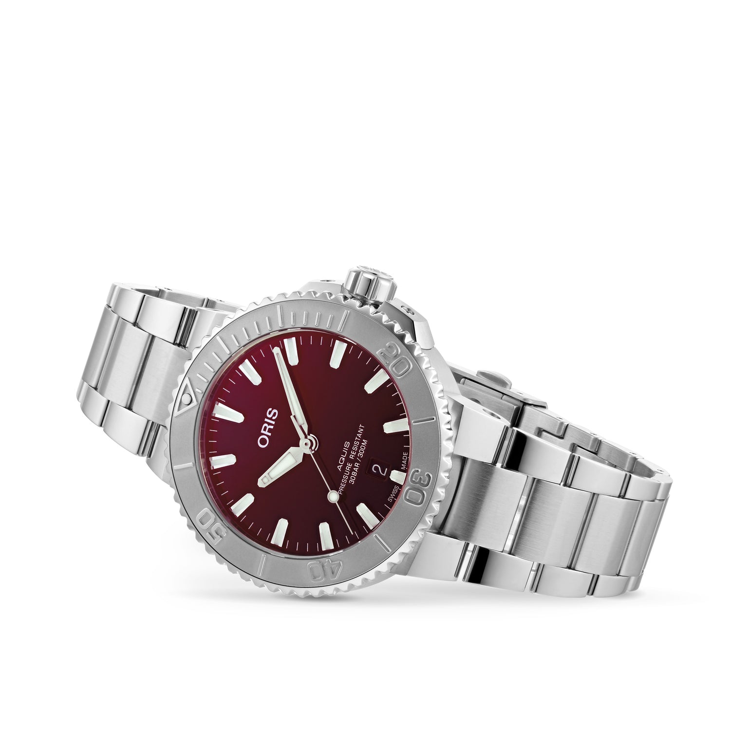 The Oris Aquis Date Relief is a stainless steel wristwatch with a red dial, white hour markers, and a unidirectional bezel, featuring the brand name on the face.