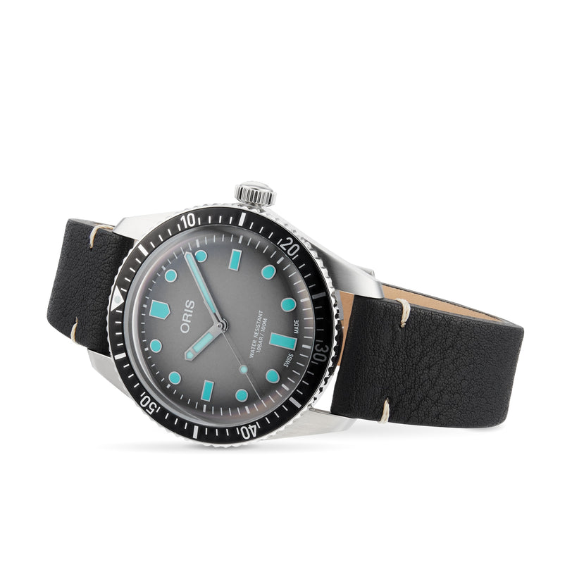 The Oris Divers Sixty-Five features a black leather strap, silver case, and blue-accented markers on a gray dial.