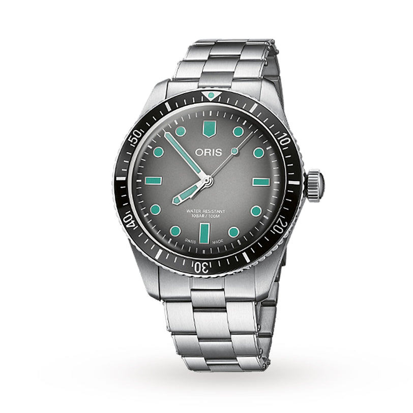 The Oris Divers Sixty‑Five features a silver case, gray dial, metal band, and turquoise hour markers, photographed on a white background.