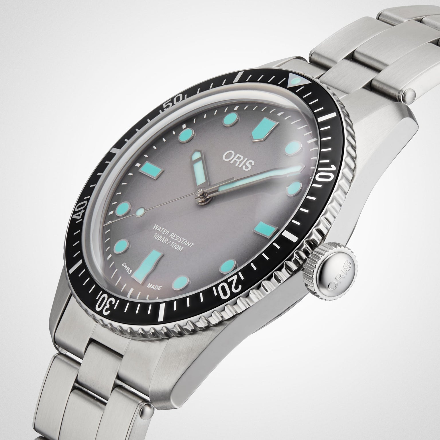 A close-up of the Oris Divers Sixty-Five wristwatch featuring a gray dial, turquoise markers, and a stainless steel strap.