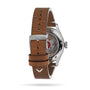 A wristwatch with a brown leather strap, shown from the back, showcases its mechanical movement through a transparent caseback—an ideal timepiece for professionals, inspired by the Oris Big Crown Oris X Cervo Volante.
