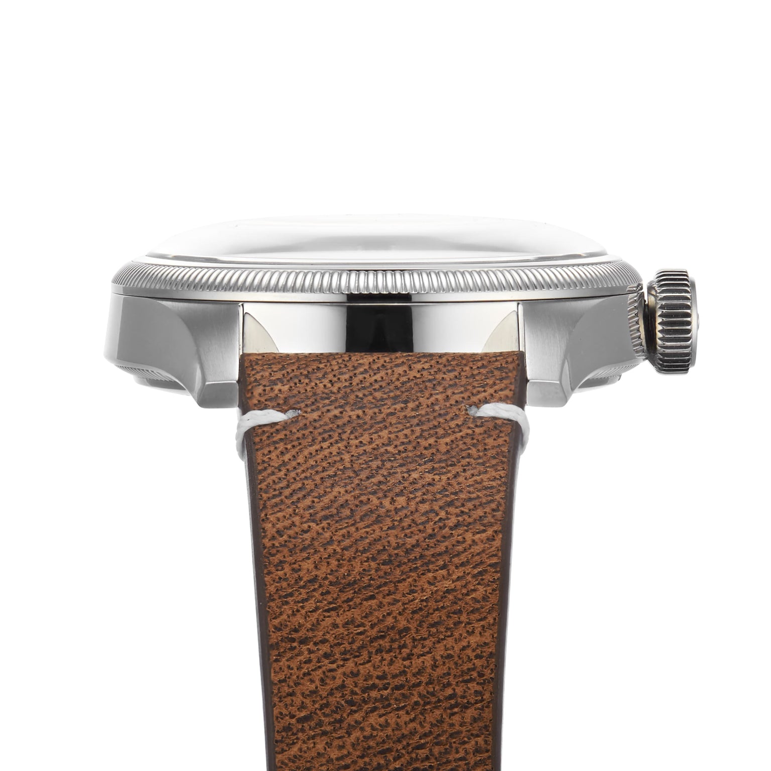 Side view of the Oris Big Crown Oris X Cervo Volante watch, showcasing a silver metal case, ridged bezel, and brown leather strap with white stitching—ideal for professionals who value both style and precision.