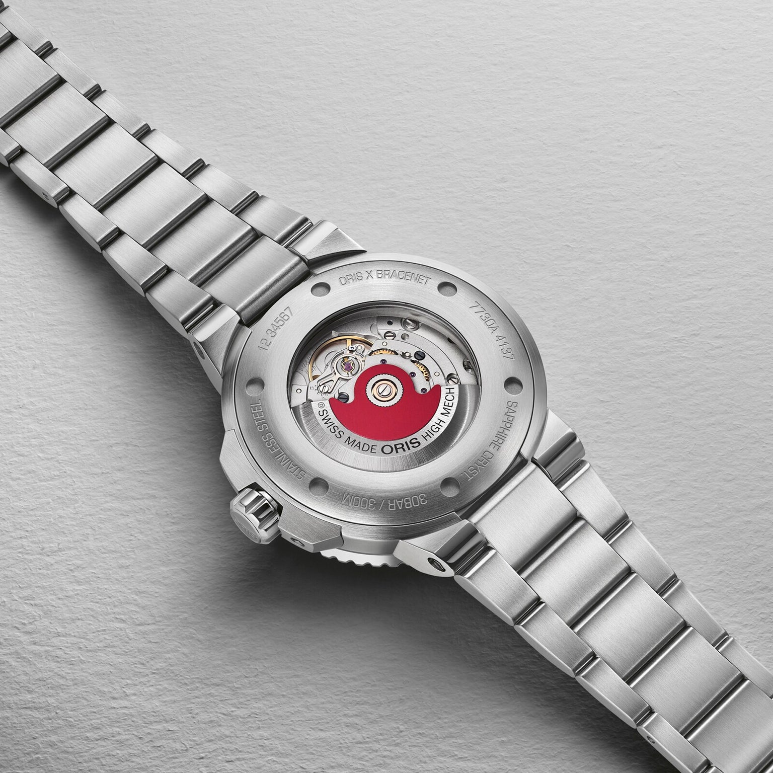 Close-up of the Oris Aquis Oris X Bracenet watch back, showcasing its exposed automatic movement and engraved details—a unique model made with upcycled ghost fishing nets.