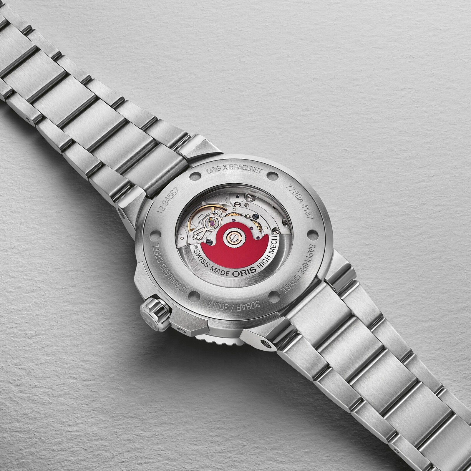 Close-up of the Oris Aquis Oris X Bracenet watch back, showcasing its exposed automatic movement and engraved details—a unique model made with upcycled ghost fishing nets.