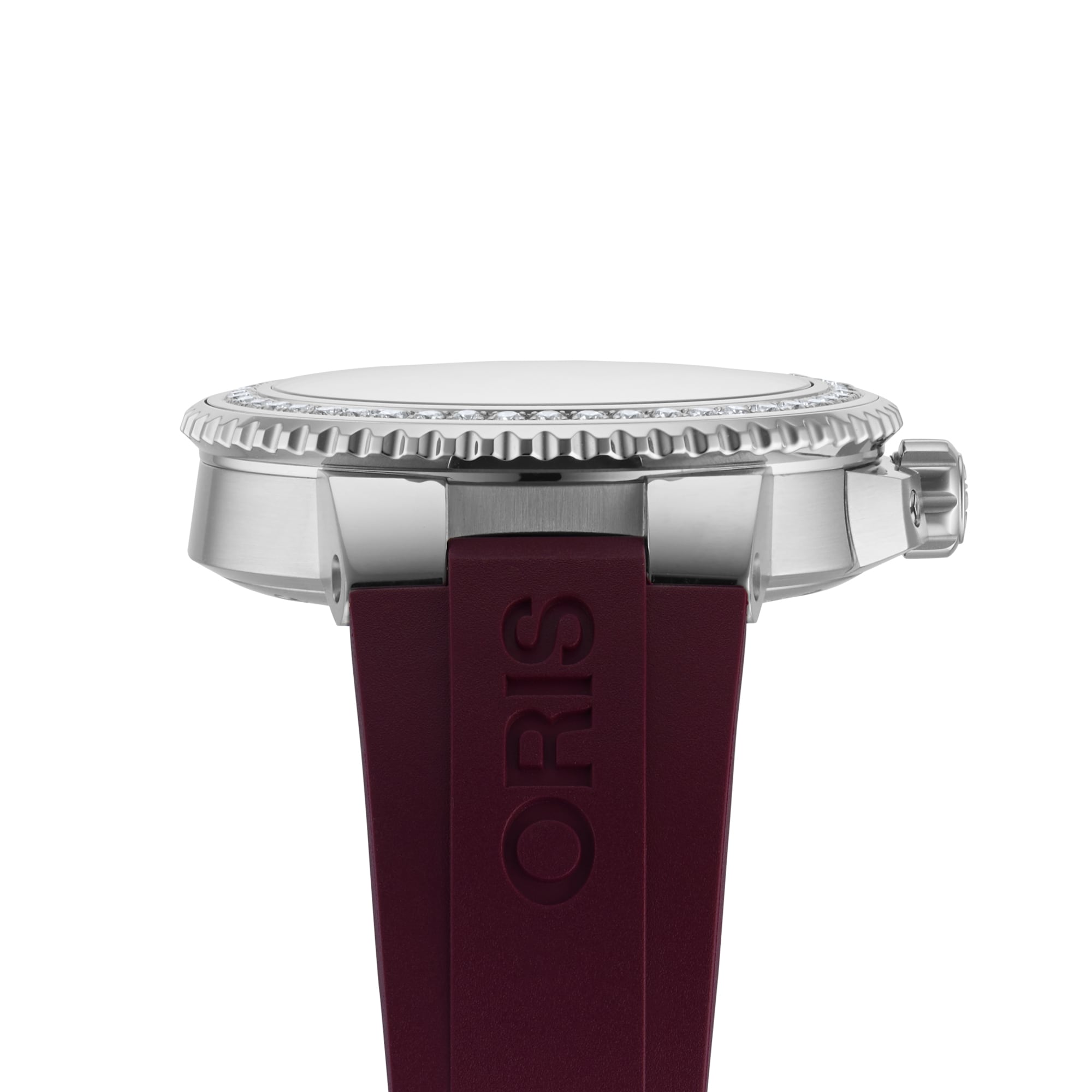 Side view of the Oris Aquis Date Diamonds wristwatch with a silver case, textured bezel, crown, and a burgundy rubber strap embossed with ORIS, showcasing the precision of Oris craftsmanship.