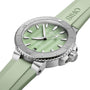 The Oris Aquis Date watch in mint green features a matching strap and silver bezel, displayed at an angle.