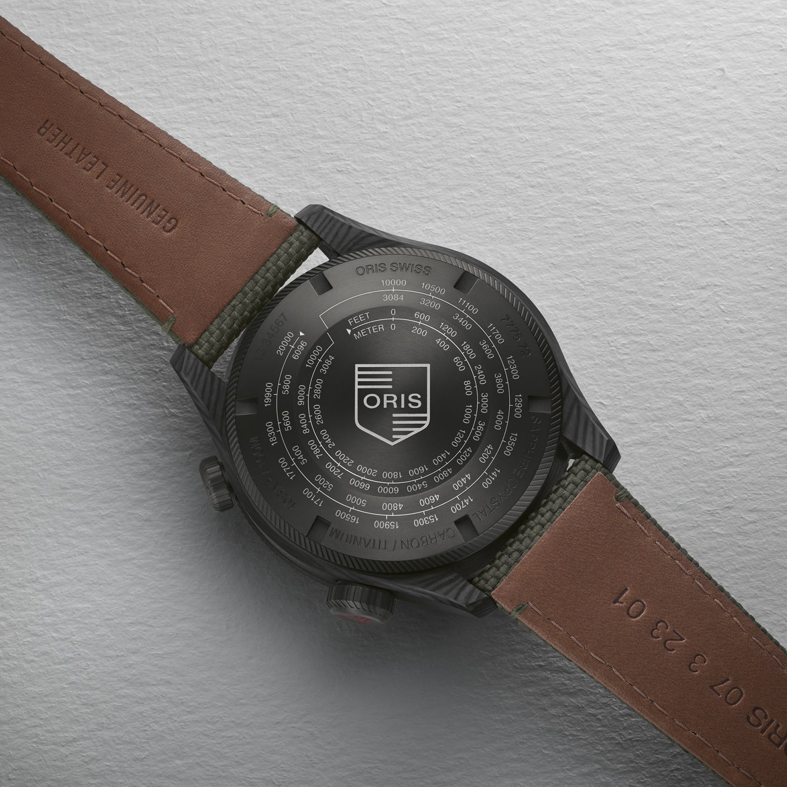 Close-up of the back of an Oris ProPilot Altimeter watch with a brown leather strap, showing technical details and calibre 793 engraved on the black case back.