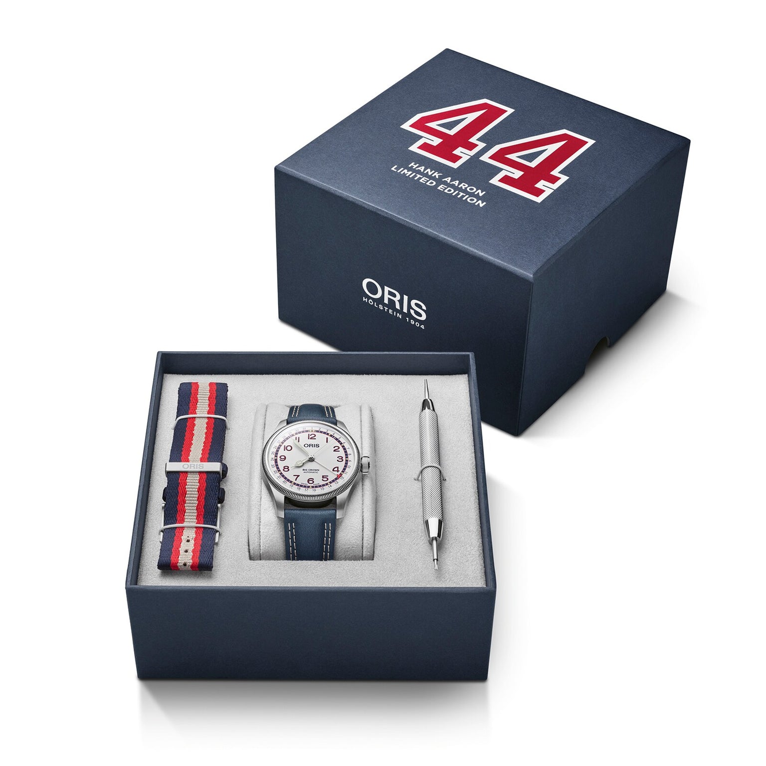The Oris Big Crown Hank Aaron Limited Edition watch comes in a box with a striped strap, stainless steel case, tool, and packaging displaying the number 44 and “MINI AM60 LIMITED EDITION” text.