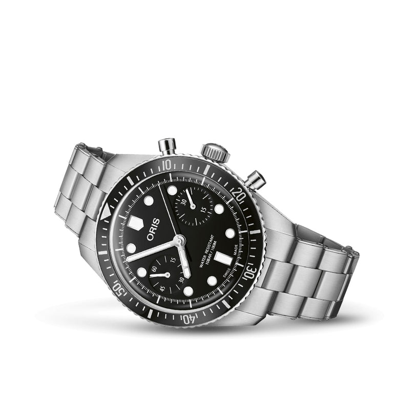 An Oris Divers Sixty‑Five Chronograph wristwatch with a silver case, black dial, metal band, and three sub-dials shown on a white background.