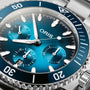 Close-up of the Oris Aquis Chronograph, featuring a blue dial with white markers, three subdials, a ceramic bezel, detailed minute and second indicators, and stainless steel construction showcasing its water resistance.