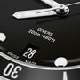Close-up of the Oris Divers Date dive watch face, showcasing automatic movement, DIVERS 200m/660ft text, a date window at 28, and part of the SWISS MADE label.