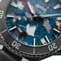 Close-up of the Oris Aquis Date Upcycle Calibre 400: a mechanical dive watch with a stainless steel bezel, silver markers and hands, date at 6 o’clock, and a multicolored marbled blue dial crafted from upcycled material.