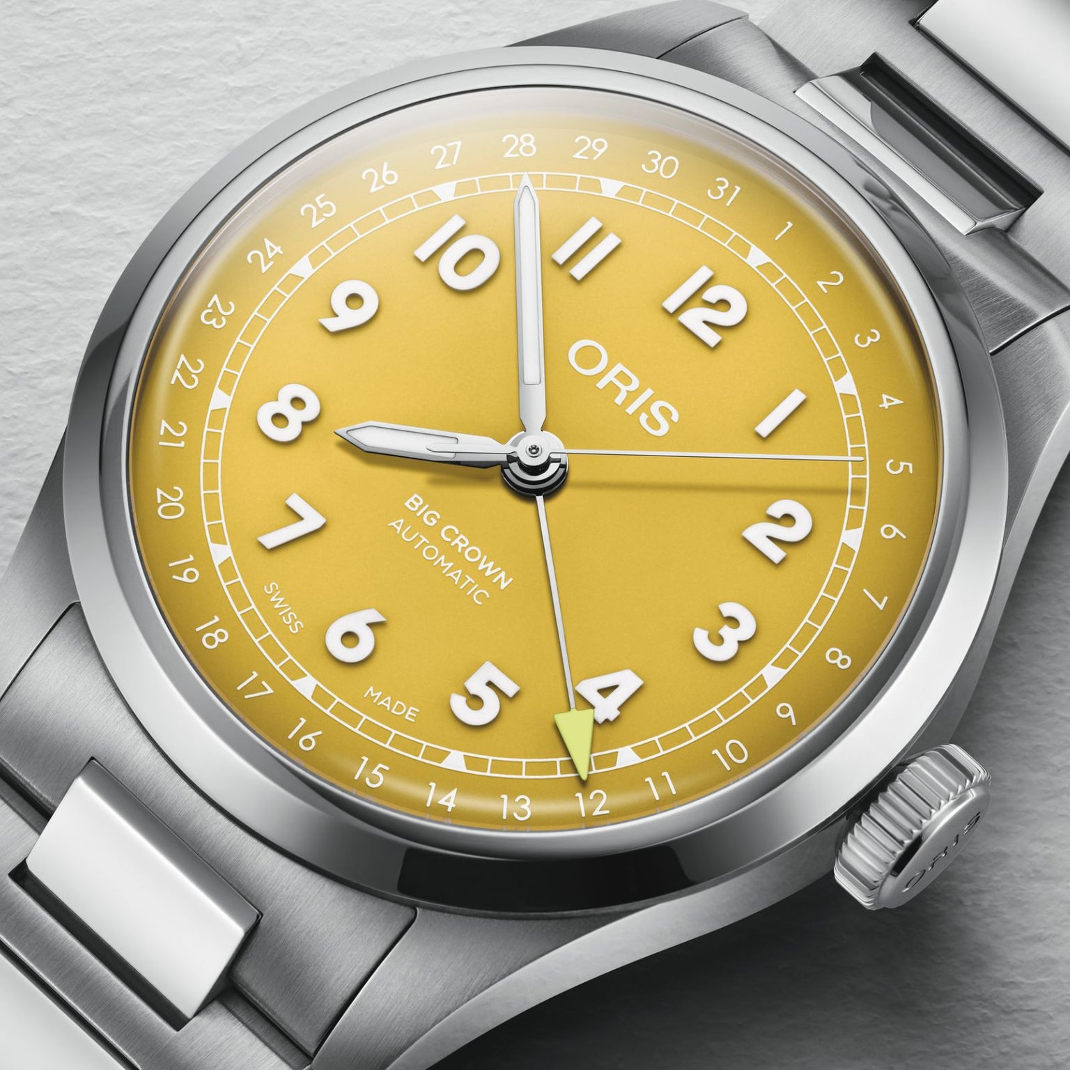 An Oris Big Crown Pointer Date wristwatch with a sunshine yellow dial, white numerals, date ring, and Swiss Made automatic mechanical movement displays 10:09:34 with the date pointer on 5.