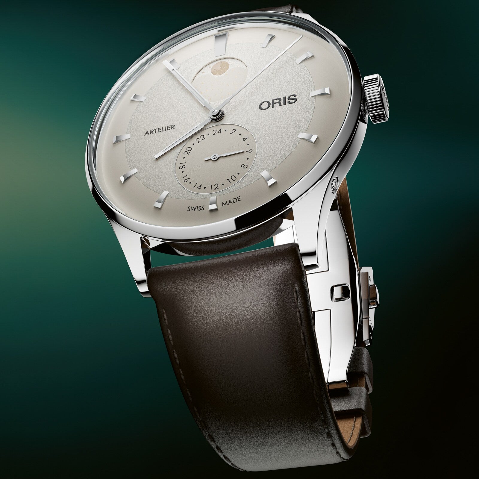 Silver-toned Oris Artelier watch with cream dial, moon phase indicator, subsidiary seconds dial, and dark brown leather strap