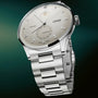 Stainless steel watch with silver dial, moon phase subdial, date window, and matching metal bracelet.