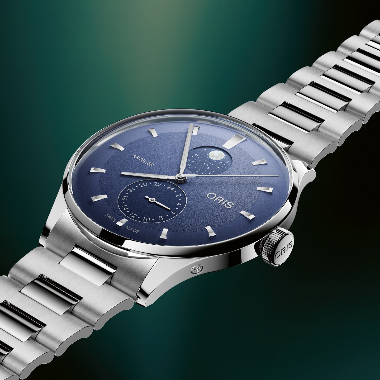 Silver stainless steel watch with blue dial, moonphase display, subdial, and matching metal bracelet.