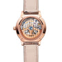 The back view of the Jaeger-LeCoultre Rendez-Vous Night & Day features a beige leather strap and rose gold case, showcasing intricate mechanical gears through its transparent caseback.
