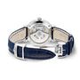 The Jaeger-LeCoultre Rendez-Vous Night & Day is a luxury women's watch featuring a visible mechanical movement, silver case, dark blue leather strap with white stitching and deployment clasp, and a light beige inner side.