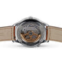 Close-up of the back of a Jaeger-LeCoultre Master watch in stainless steel, featuring a transparent case showing off the intricate mechanical movement, visible leather strap, and engraved rim markings.