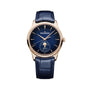 The Jaeger-LeCoultre Master Ultra Thin Moon Navy pairs a blue leather strap with a gold case and blue dial, showcasing gold hour markers, slender hands, and a moon phase subdial with date at 6 o’clock—true elegance.