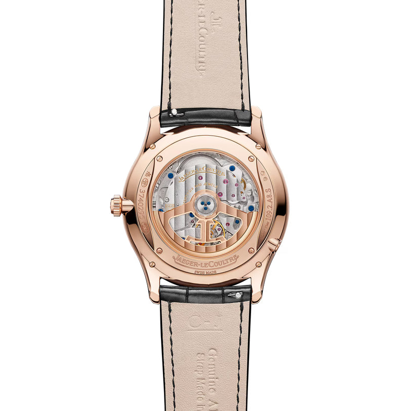 A close-up of the Jaeger-LeCoultre Master Ultra Thin Perpetual Calendar Automatic in rose gold, highlighting its intricate mechanical movement through a transparent case back and paired with a black leather strap.