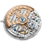 Close-up of the Jaeger-LeCoultre Polaris Perpetual Calendar's movement, showcasing intricate gears, blue screws, and a gold-colored rotor—a testament to the fine craftsmanship found in luxury timepieces.