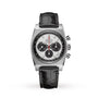 The Zenith Chronomaster Revival El Primero A384 features a stainless steel case, black leather strap, white dial with three black subdials, El Primero movement, and bold tachymeter markings.