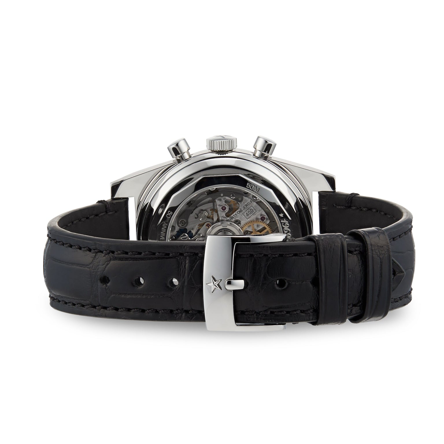 The Zenith Chronomaster Revival El Primero A384 is a mechanical wristwatch with a black leather strap, visible El Primero movement through the caseback, and a sleek silver buckle.