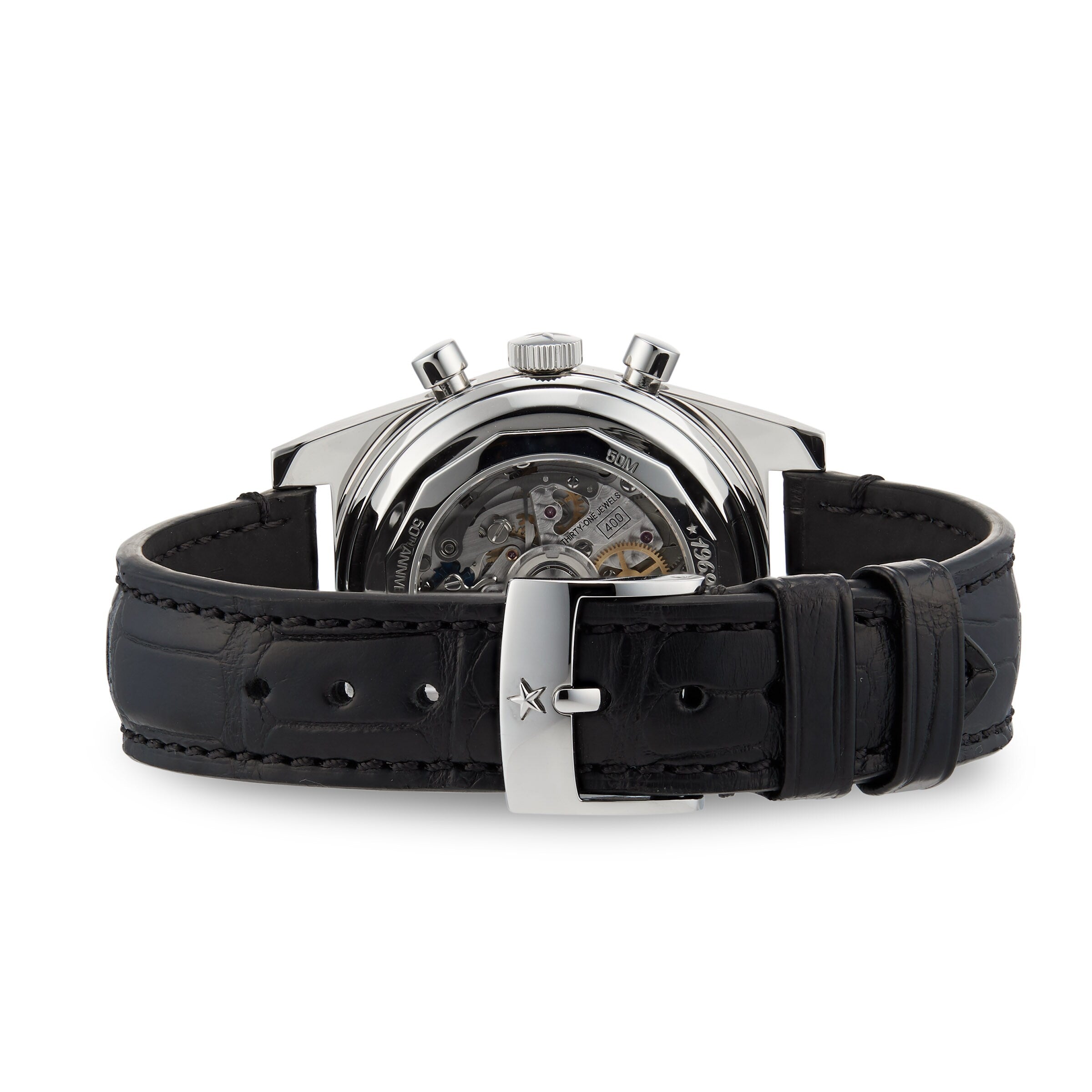 The Zenith Chronomaster Revival El Primero A384 is a mechanical wristwatch with a black leather strap, visible El Primero movement through the caseback, and a sleek silver buckle.