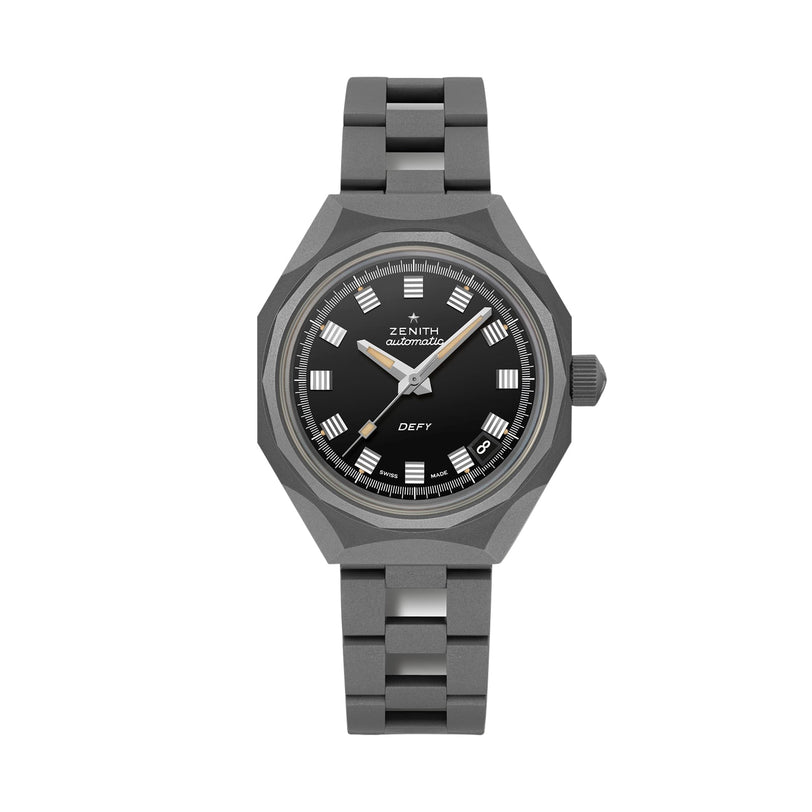 The Zenith Defy Revival Shadow wristwatch has a titanium case, black dial with Roman numeral markers, silver hands, and a silver metal bracelet, shown against a white background.