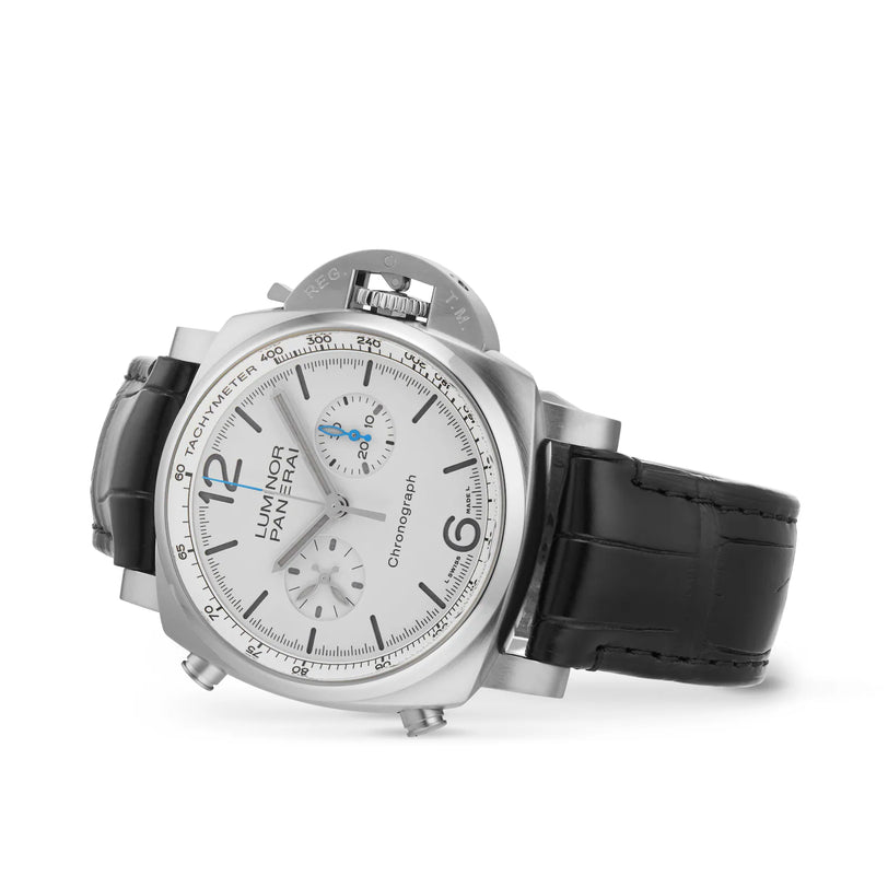 The Panerai Luminor Chrono features a silver dial, black leather strap, and three subdials, displayed at an angle on a white background—a striking piece in the Panerai collection.