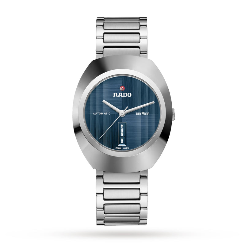 A Rado DiaStar Original wristwatch with a blue dial, metallic strap, sapphire crystal, day-date display, and Automatic on the face is shown against a white background.