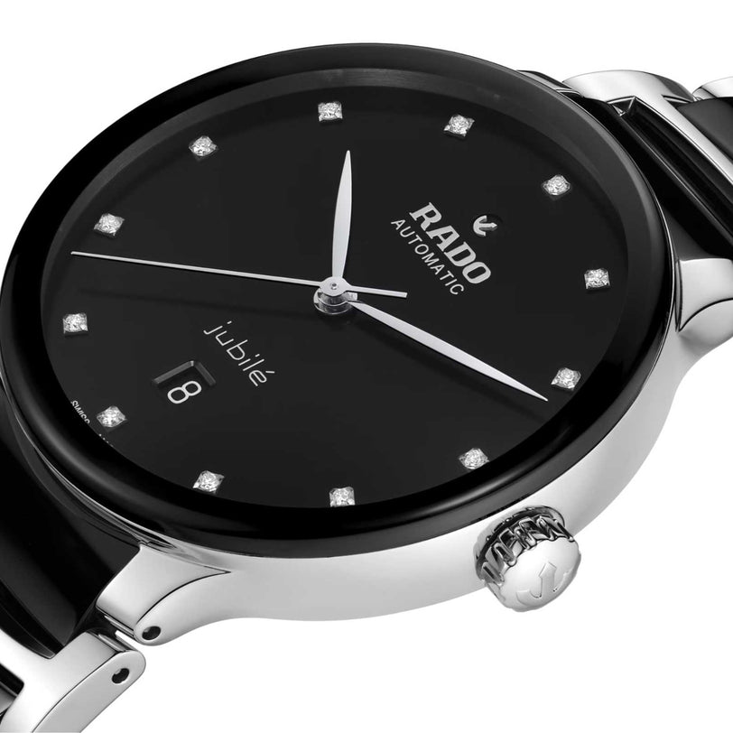 Close-up of the Rado Centrix Automatic Diamonds wristwatch featuring a black dial, diamond hour markers, date display at 6 oclock, and a stainless steel case and band with sapphire crystal.
