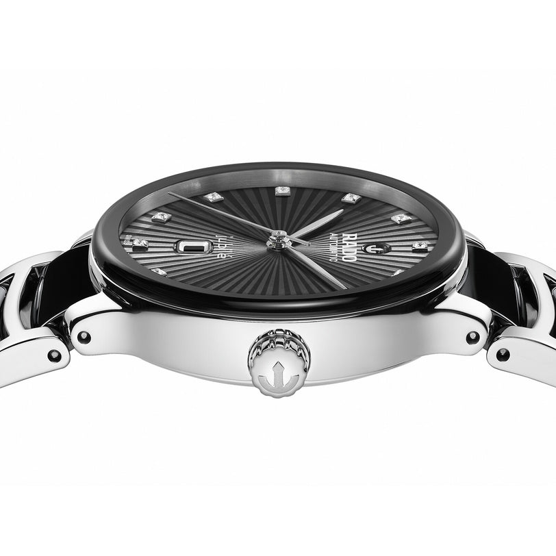 Close-up side view of the Rado Centrix Automatic Diamonds watch in silver with a black sunburst-patterned dial, diamond hour markers, high-tech ceramic details, and a crown embossed with the logo.