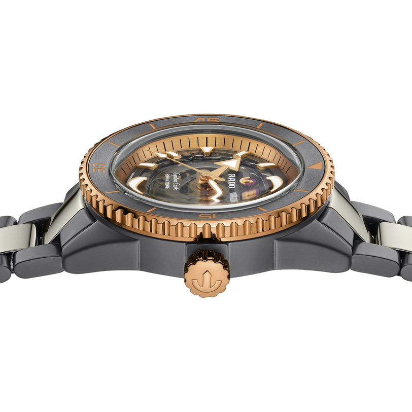 A close-up side view of the Rado Captain Cook High-Tech Ceramic Skeleton wristwatch, featuring a black and gold bezel, metallic casing, logoed crown, and a partially visible skeletonized dial powered by the R808 movement.